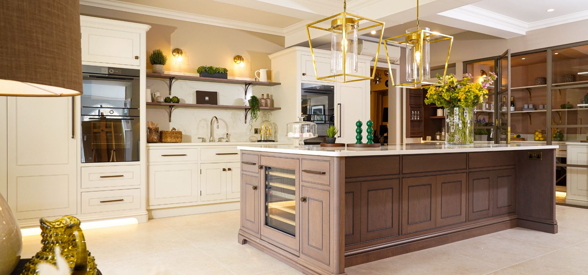 Modern kitchen with wooden island, white cabinets, and decorative elements.
